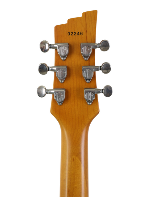 Back of a guitar headstock with tuning pegs and a serial number 02246 on white background.