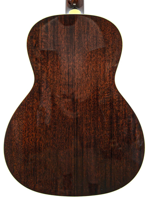 Back of an acoustic guitar with a rich wood grain texture on a white background.