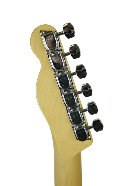 Back of an electric guitar headstock with six tuning pegs against a white background.
