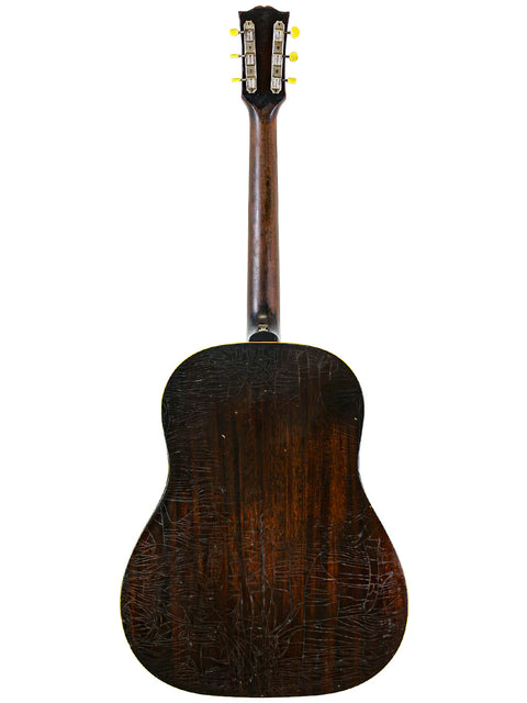 Back view of a 1953 Vintage Gibson J-45 acoustic guitar, emphasizing its stunning wooden back and vintage appeal.