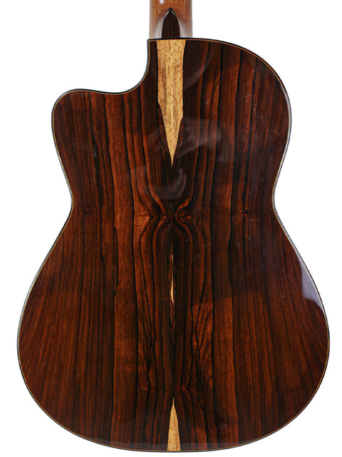 Back view of a wooden acoustic guitar with a distinctive grain pattern.