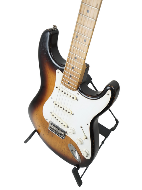 Black-bodied guitar with a white pickguard, representing the Nacho Guitars 50s Stratocaster, Spain 2024 edition.