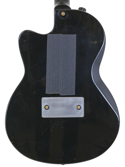 Black Gibson Chet Atkins SST guitar, USA-made in 2001, with a unique metal plate affixed to the back.
