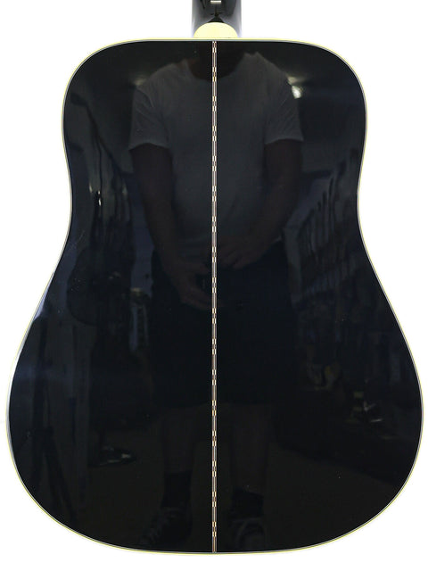 Black Gibson Custom Shop Elvis Dove guitar displayed on a white backdrop, emphasizing its classic style.
