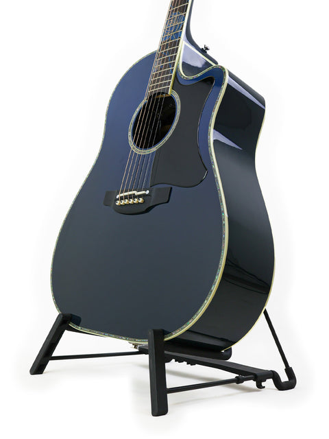 Black acoustic guitar displayed on a stand, featuring the Takamine LTD2021 Limited Edition "Blue Rose" from Japan, 2021.