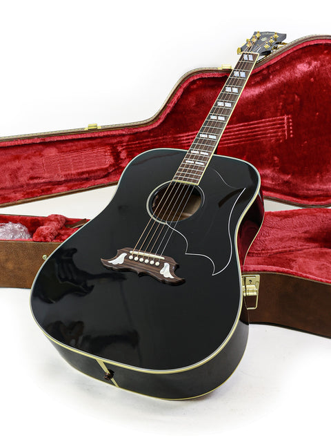 Black acoustic guitar housed in a case, representing the Gibson Custom Shop Elvis Dove from the USA, 2023.