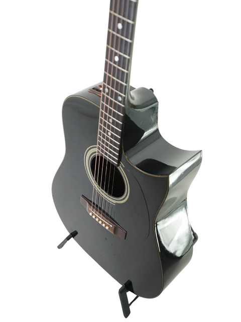 Black acoustic guitar on a stand, showcasing the vintage Maton Tommy Emmanuel 'Ebony' Signature from 1989, AUS.