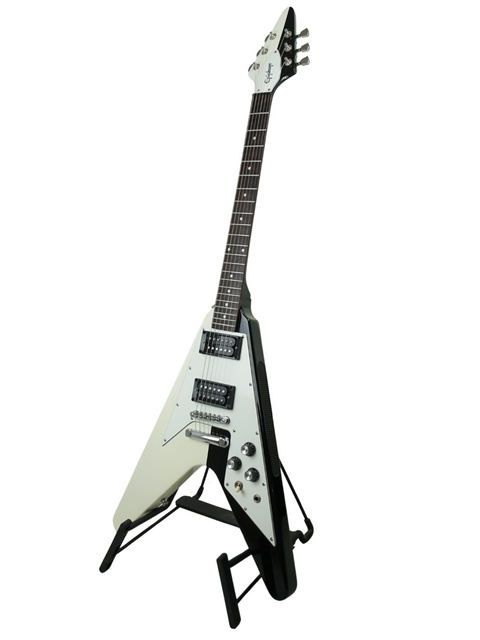 Black and white V-shaped electric guitar on a stand with white background.