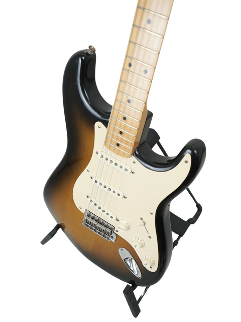Black body Fender Eric Johnson Signature Stratocaster guitar with a white pickguard, USA-made, from 2005.