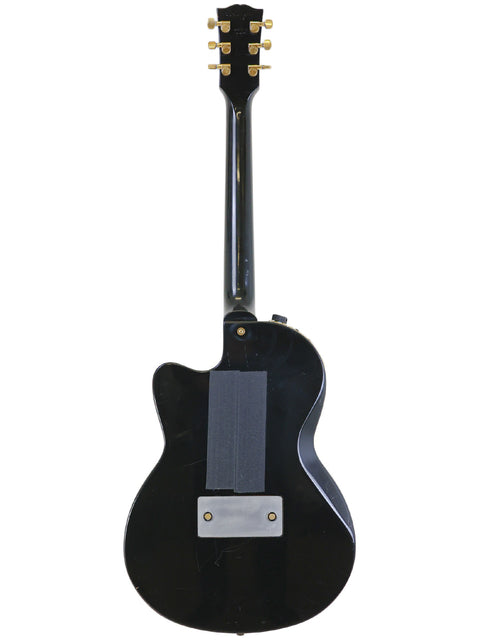 Black electric guitar featuring a white pickguard, identified as Gibson Chet Atkins SST, USA, from the year 2001.
