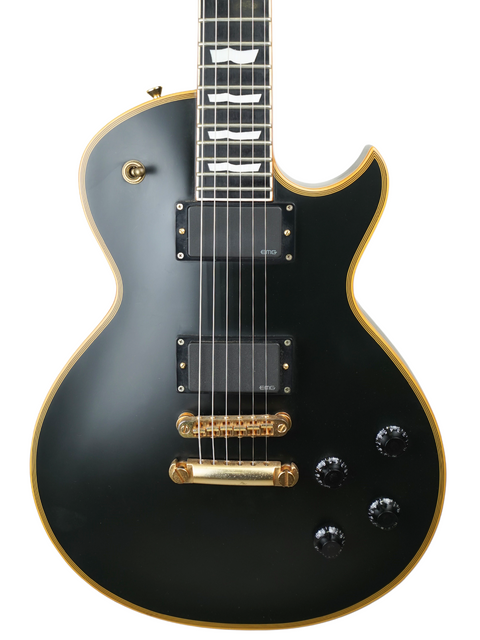 Black electric guitar with gold accents and white inlay on the fretboard.