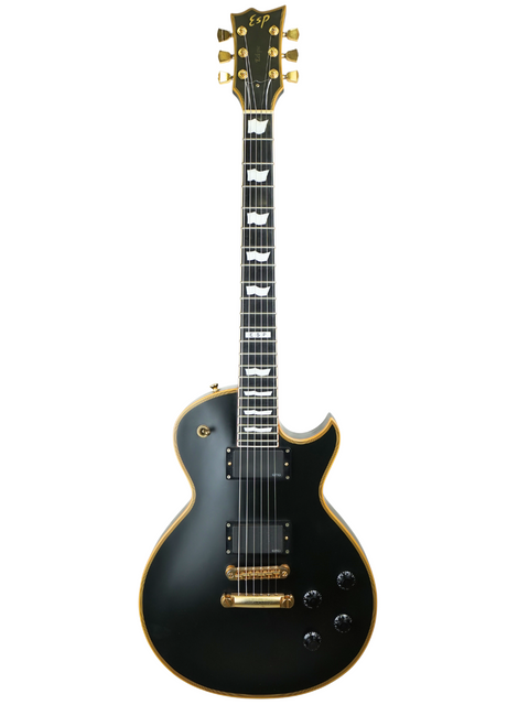 Black electric guitar with gold details and white inlays on fretboard.