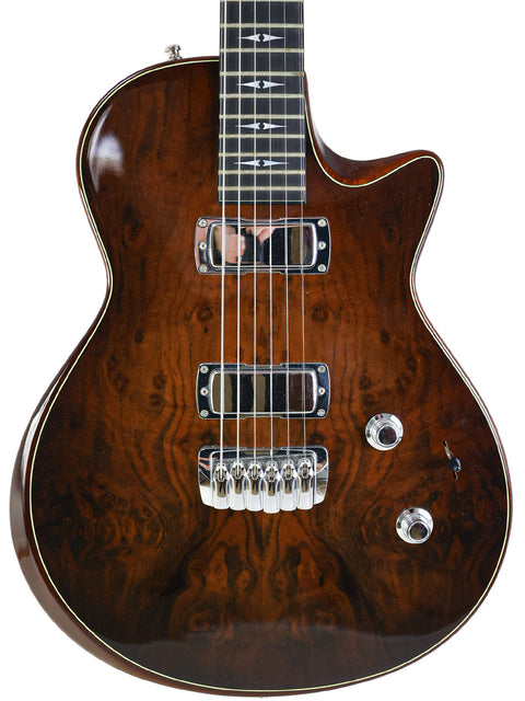 Brown Taylor Solid Body guitar from 2007, showcasing a beautiful wooden body and neck, ideal for strumming your favorite tunes.