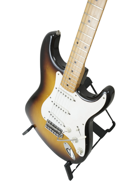 Classic 1957 Fender Stratocaster featuring a black body and white pickguard, inspired by the legendary Hank Marvin.