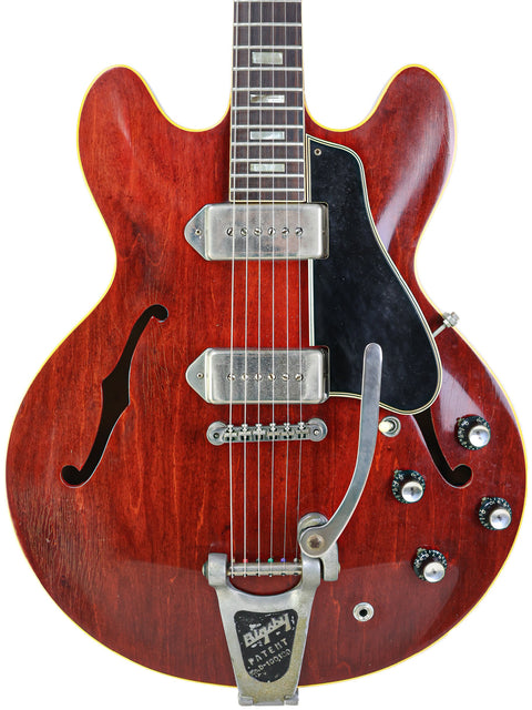 Classic 1965 Gibson ES-330 in red with a black pickup, representing timeless guitar artistry.