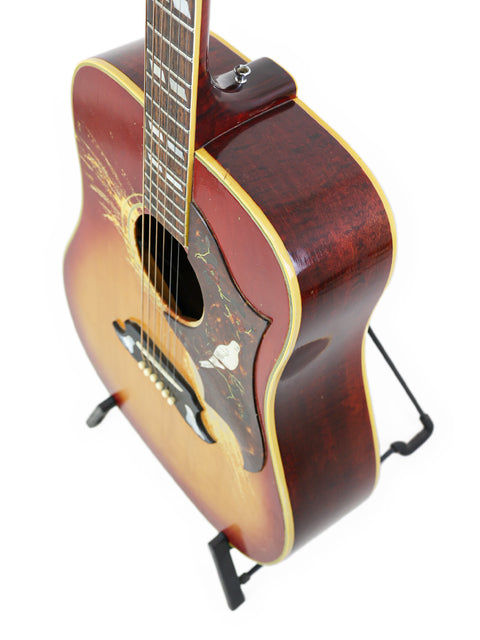 Classic 1968 Gibson Dove guitar in red and black, exemplifying vintage charm and exceptional craftsmanship.