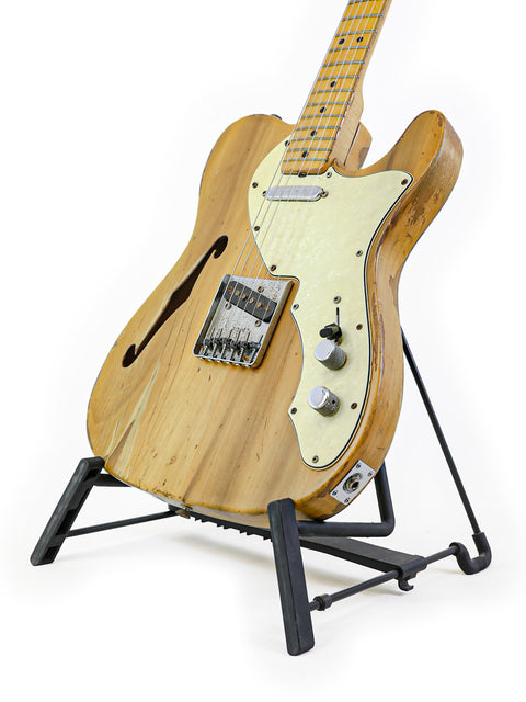 Classic 1971 Fender Telecaster Thinline guitar resting on a stand, set against a pristine white background.
