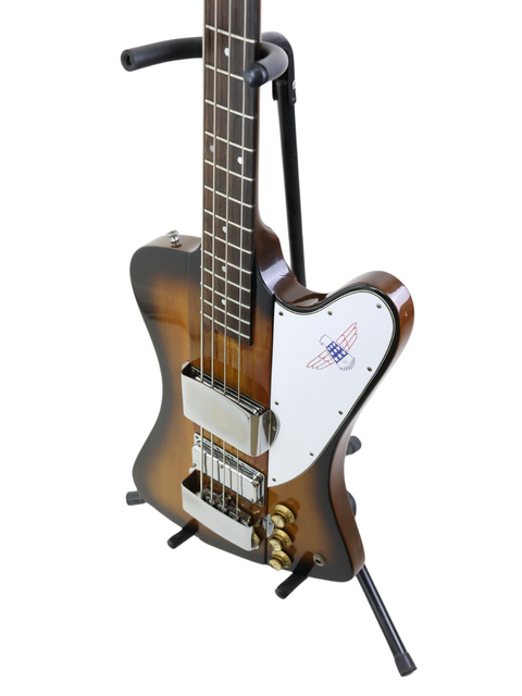 Classic 1976 Gibson Bicentennial Thunderbird IV Bass on a stand, featuring a guitar strap, perfect for musicians and collectors.