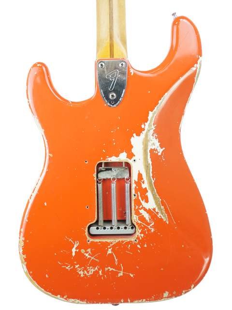 Classic 1979 Fender Stratocaster in bright orange, complete with a stylish white pick guard, ideal for vintage enthusiasts.