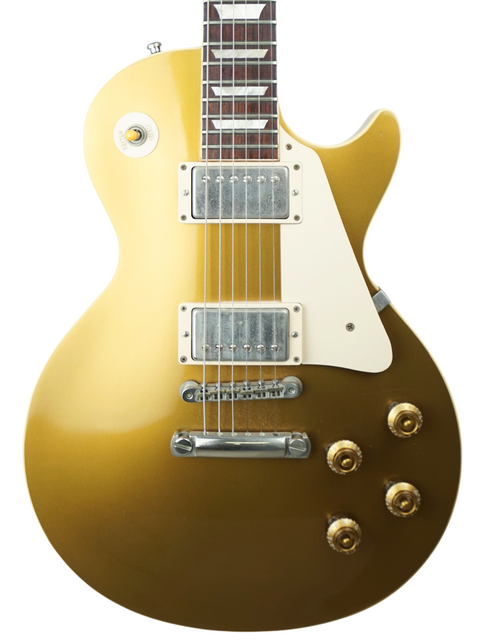 Classic Gibson Les Paul Custom Goldtop from 2003, featuring a striking gold finish and vintage-inspired design.