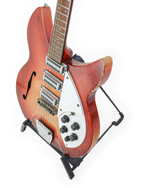 Classic Rickenbacker 1998 (345) guitar on a stand, highlighted by a simple white background, capturing its vintage charm.