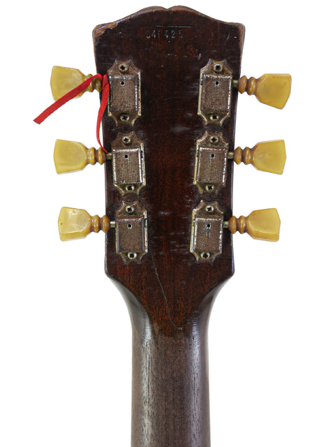 Close-up image of the headstock from a 1962 Gibson ES-175D acoustic guitar, emphasizing its vintage style and quality.