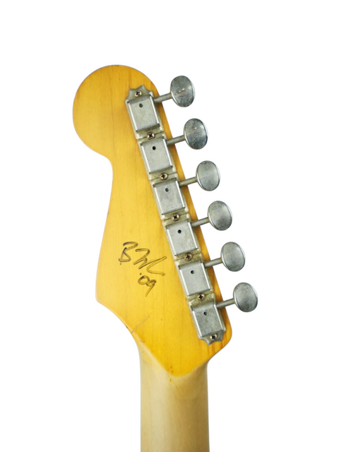 Close-up image of the headstock of a 2009 Nash S63 Stratocaster Relic, emphasizing its classic style and intricate details.
