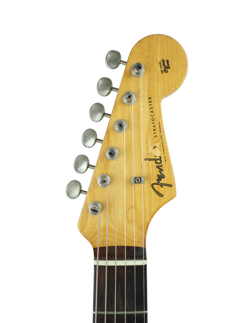 Close-up of a 1959 USA Fender Stratocaster headstock, featuring the distinctive slab board and vintage craftsmanship.