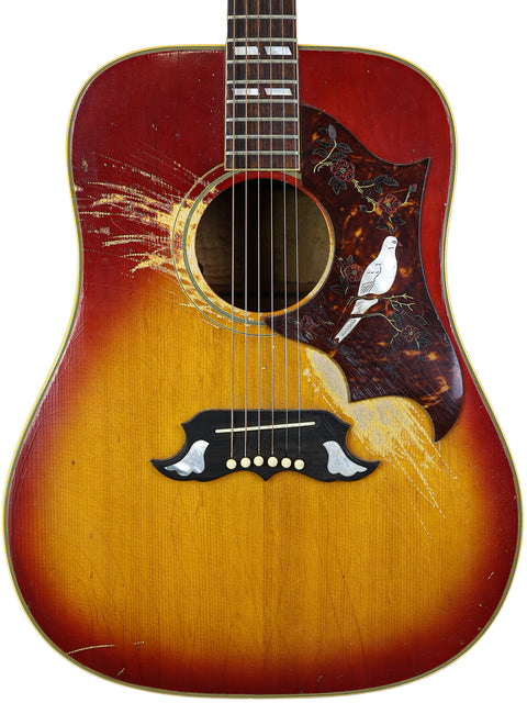 Close-up of a 1968 Gibson Dove acoustic guitar, adorned with a bird on the back, representing classic American craftsmanship.