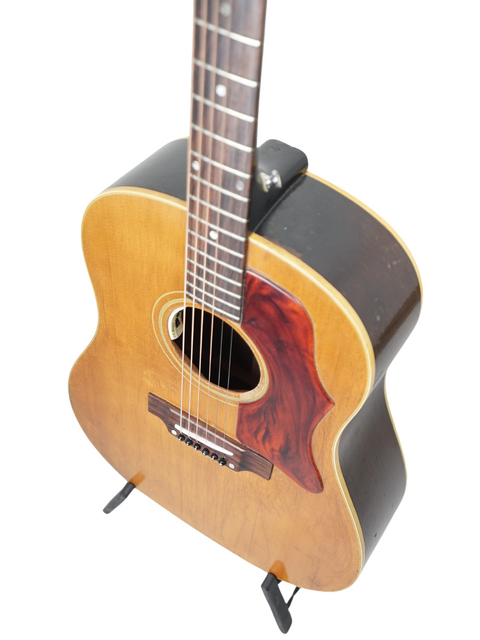 Close-up of a 1968 Gibson J-50 guitar, highlighting its elegant wooden body and neck, a true vintage musical treasure.