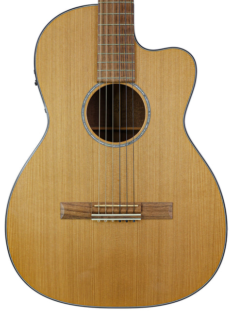 Close-up of a 2003 Martin 000C-16SGCTNE guitar, showcasing its elegant wooden body and neck design.