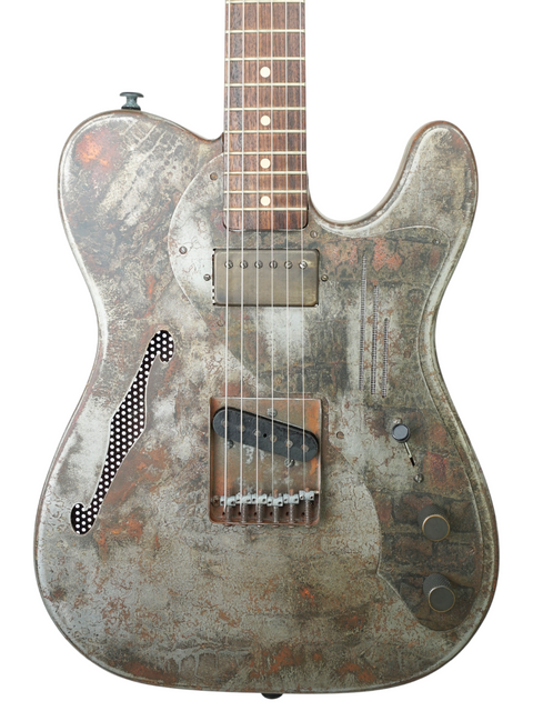 Close-up of a 2006 James Trussart Steelcaster guitar, featuring a rustic finish that highlights its artistic details.