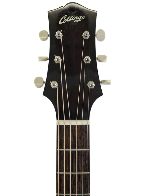 Close-up of a Collings guitar headstock and upper neck with tuning pegs visible.
