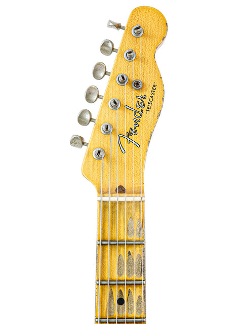 Close-up of a Fender Custom Shop '53 Telecaster Heavy Relic guitar head with a vibrant yellow body, showcasing intricate details.