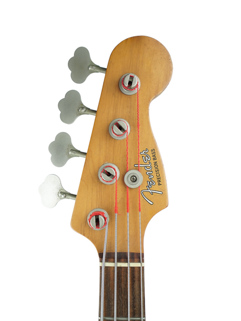 Close-up of a Fender Precision Bass guitar headstock with tuning pegs.