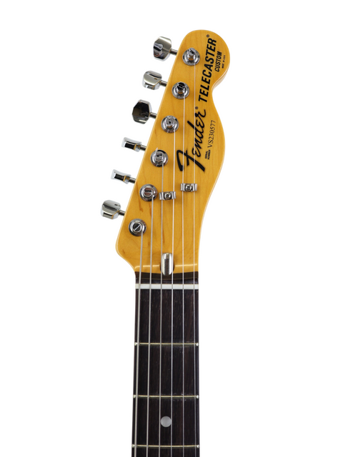 Close-up of a Fender Telecaster guitar headstock and neck on a white background.
