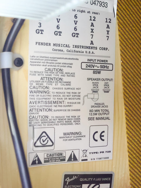 Close-up of a Fender amp label with safety warnings, input power specs, and certifications.