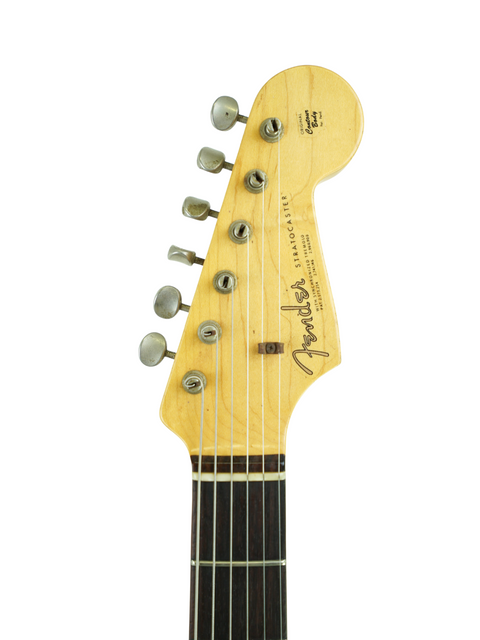 Close-up of a Fender guitar headstock featuring the '63 Michael Landau Stratocaster Relic from the Custom Shop, USA 2015.