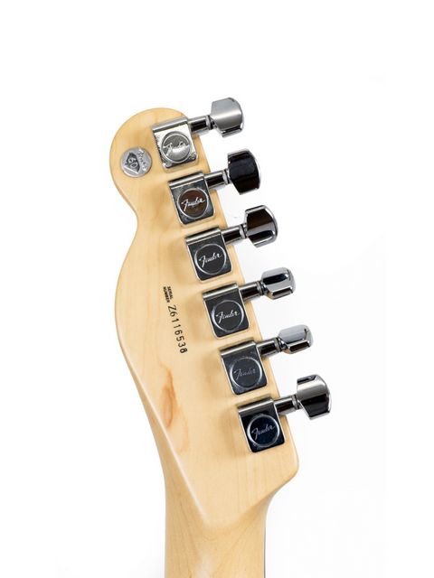 Close-up of a Fender guitar headstock with six tuning pegs against a white background.