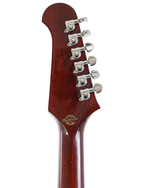 Close-up of a Gibson Custom Shop Trini Lopez guitar head, showcasing its elegant wooden body and intricate design details.