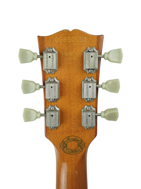 Close-up of a Gibson Les Paul Deluxe headstock with four knobs, marking the 30th Anniversary Limited Edition from 2000.