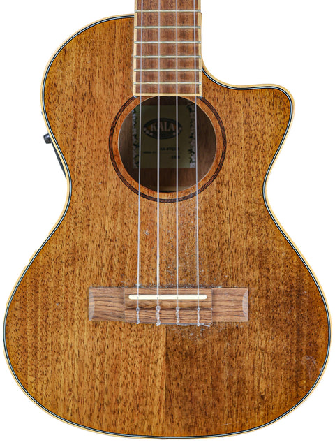 Close-up of a Kala KA-KTGE-C ukulele, featuring a mahogany body and wooden neck, highlighting its craftsmanship.
