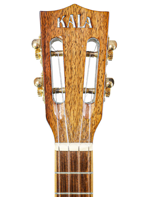 Close-up of a Kala Koa tenor ukulele, highlighting its beautiful koa wood finish and cutaway shape, ideal for vibrant sound.
