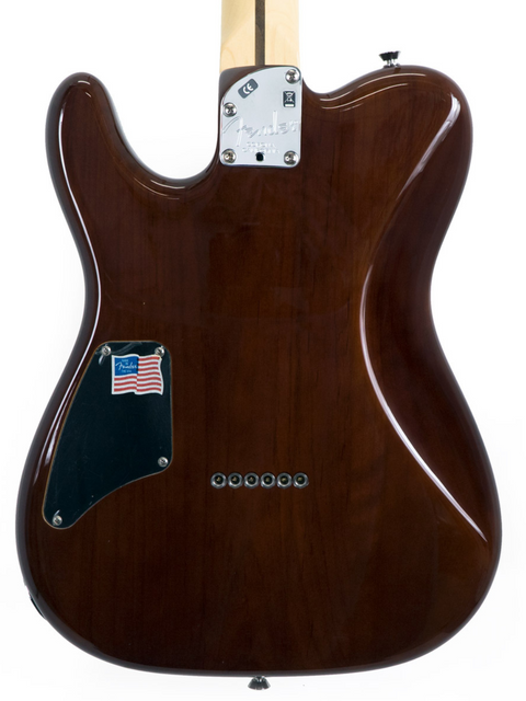 Close-up of a brown Fender electric guitar body with a glossy finish.