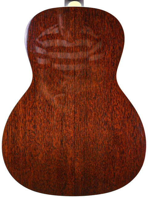 Close-up of a brown wooden guitar's body with visible grain patterns.