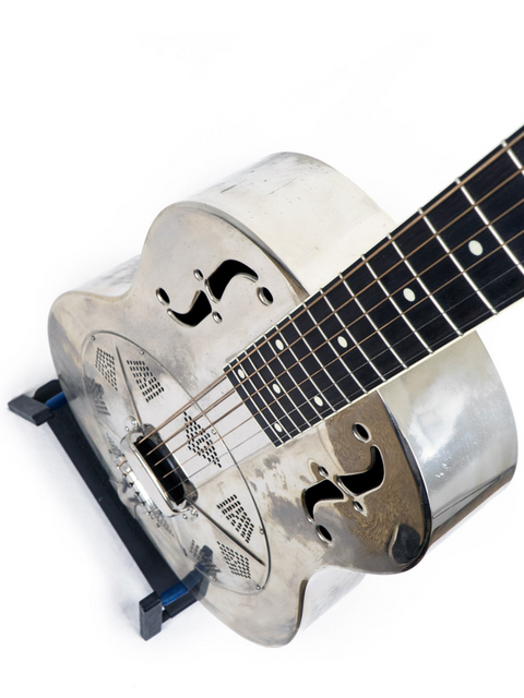 Close-up of a silver 2001 National Resophonic Style N Resonator guitar, showcasing its elegant black pick guard.