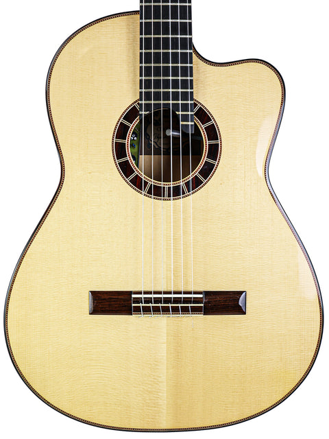 Close-up of an acoustic guitar front with strings and sound hole visible.