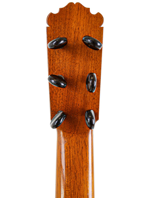 Close-up of an acoustic guitar headstock, emphasizing the tuning pegs and M.G. Contreras label, Calle Mayor 80, Spain 1973.