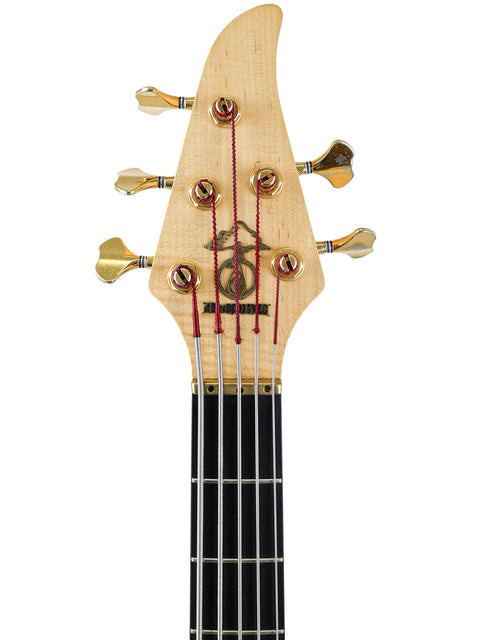Close-up of the Alembic Orion 5-string bass guitar headstock, featuring gold tuners and Alembic logo, USA 1999.