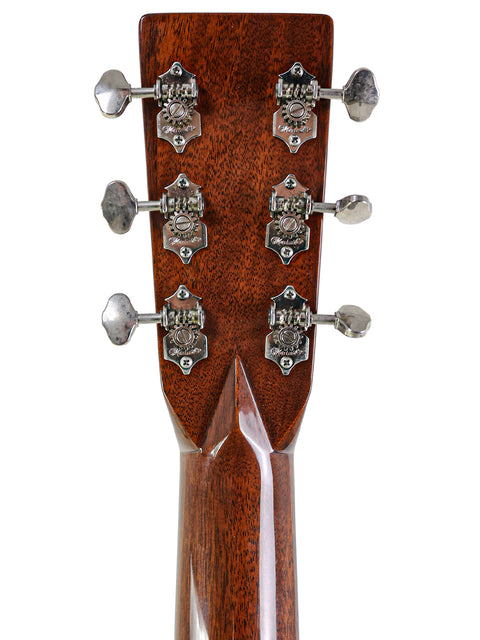 Close-up of the headstock from a 2006 Martin 000-28EC Eric Clapton Signature guitar, showcasing four tuning knobs.